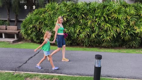 mother and daughter walking in a park