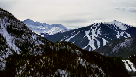 distant copper mountain colorado winter december christmas aerial drone cinematic landscape i70 leadville silverthorne vail aspen ten mile range cloudy rocky mountains upward reveal