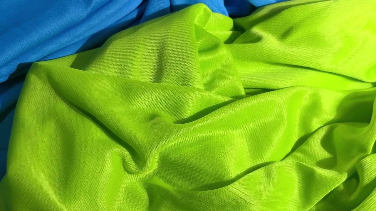 Fundo de Textura de Tecido Verde Neon Vibrante e Azul Brilhante.