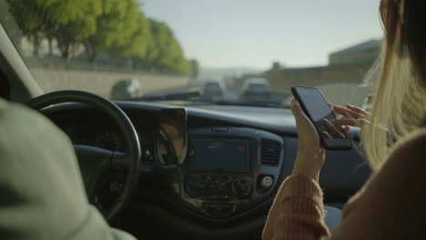 chica usando teléfono inteligente en el coche