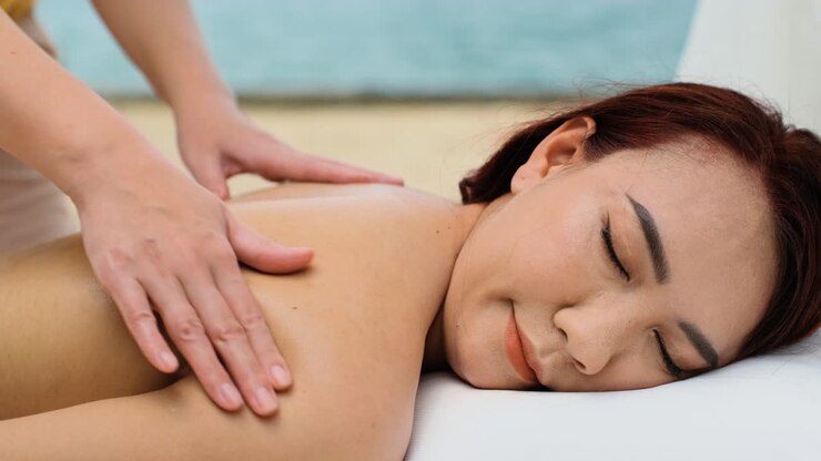 Masseuse giving massage to woman