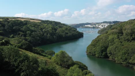 low aerial view flying along the river fowey, in cornwalls area of outstanding natural beauty towards fowey town