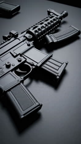 close-up of a black rifle and magazines