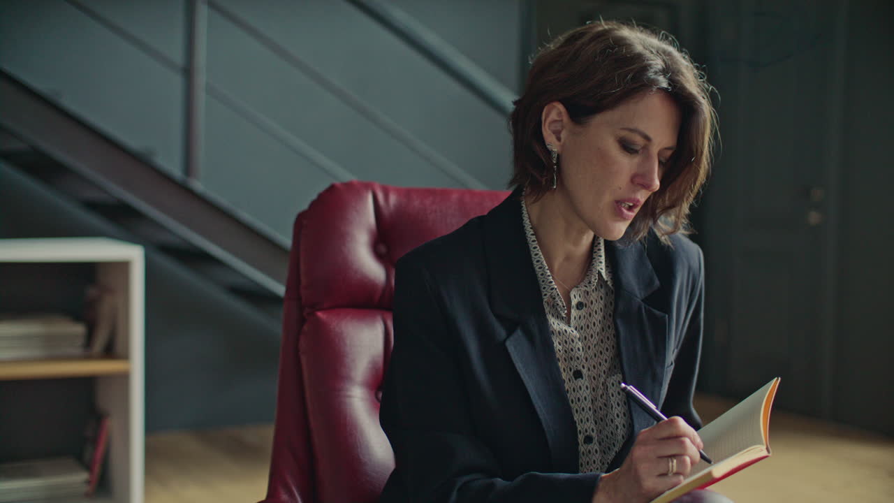 Professional Female Psychologist Taking Notes on Therapy Session with Client