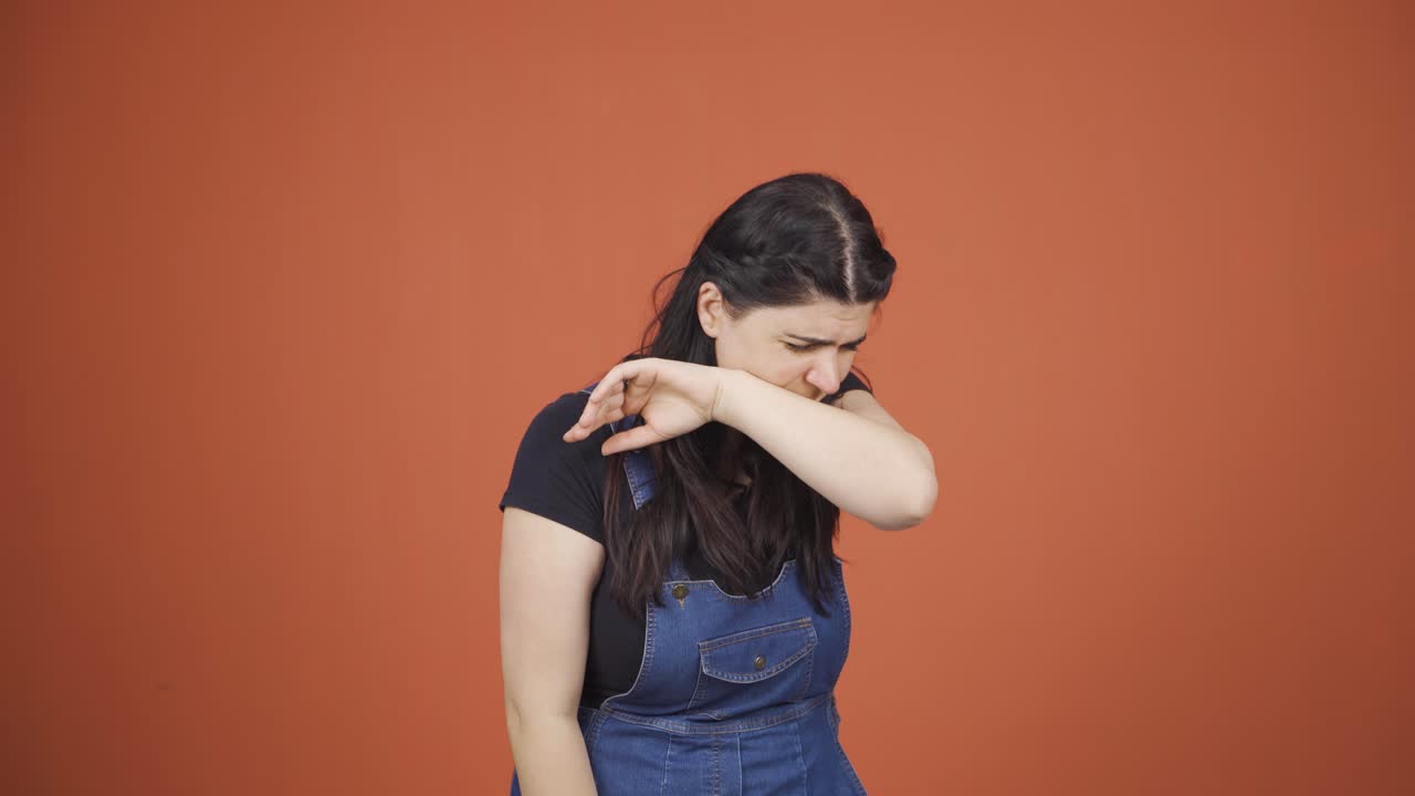 Sick woman coughing.