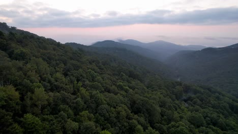 fast aerial push over treetops at sunrise near boone and blowing rock nc, north carolina