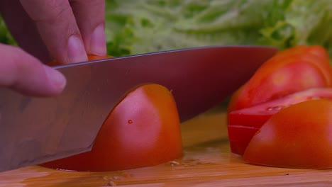 beautiful close up shot of a professional chef slicing through a juicy tomato