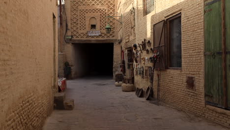 sunlit traditional arabic alley in sbeitla with intricate architecture and handicrafts