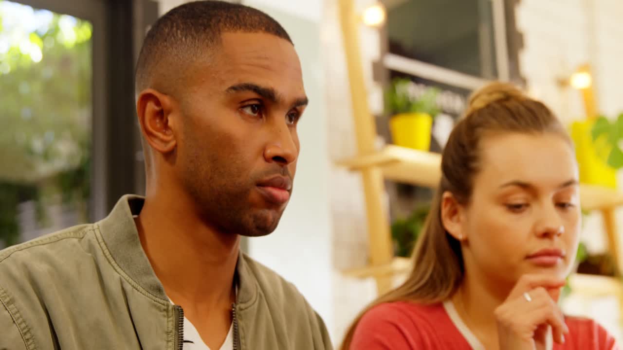 Couple using mobile phone while having lunch 4k