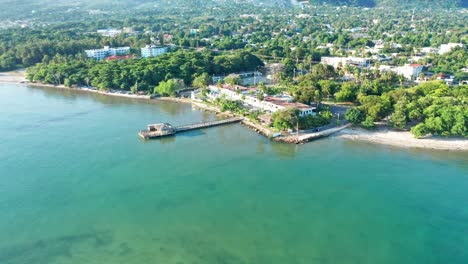 Aerial-view-of-Hotel-Guarocuya-with-tennis-court,private-beach-and-clear-Caribbean-Sea-during-summer