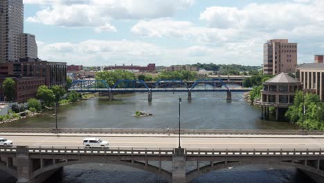 Grand-Rapids,-Michigan-bridges-over-Grand-River-with-low-drone-video-moving-forward