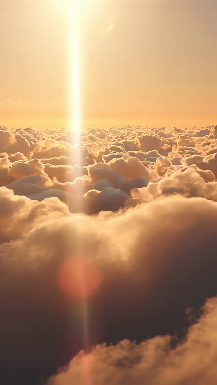 Vertical video: Sequence starting drone descending over cloud deck, capturing sunbeam, lens flare