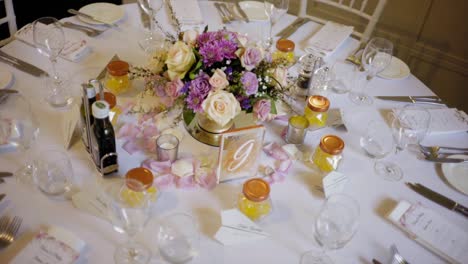 table flower shown with glass oliver oil and some candles centrepiece