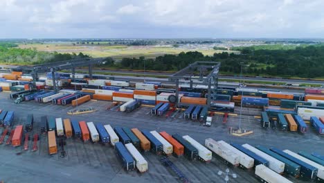 4k drone video of trains and trucks at csx intermodal train yard in winter haven, fl