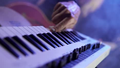 Female-singer-hands-playing-on-synthesizer-piano