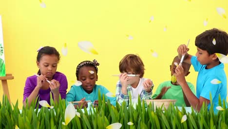 Animation-of-multi-ethnic-group-of-children-decorating-Easter-eggs-on-yellow-background