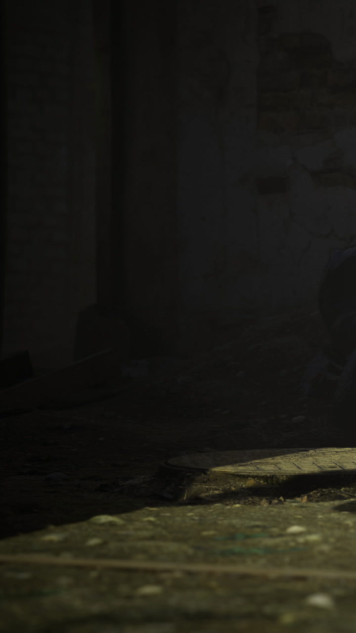 Man sits on floor with low light in old building during evening hours