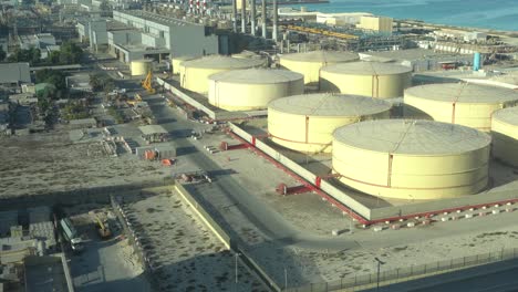 middle east water and gas containers along the coastline for gas, water and oil concepts. industrial zone.