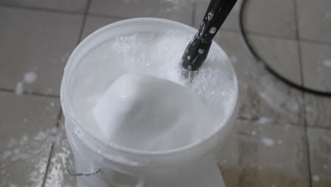 car wash bucket with soap and bubbles