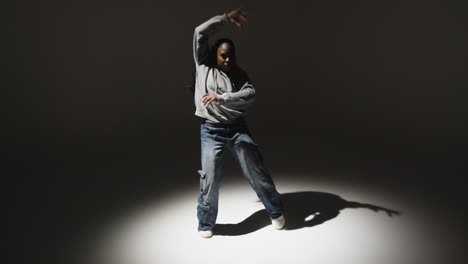 Full-Length-Studio-Portrait-Shot-Of-Young-Woman-Dancing-In-Spotlight