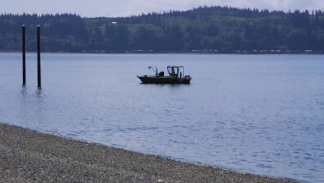 small, nondescript fishing floating near dock at camano island state park, wa state 10sec-60fps version 4