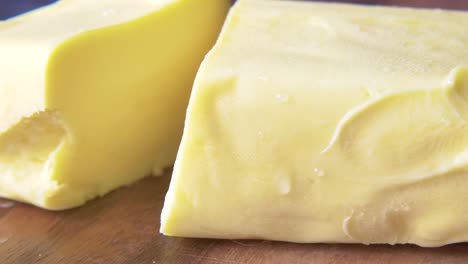 sliced butter on wooden cutting board