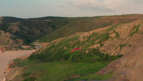 Aerial:-A-man-soaring-down-a-cliff-in-Portugal