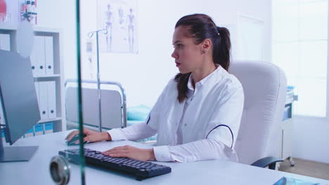 Medic-wearing-white-coat-in-hospital-cabinet