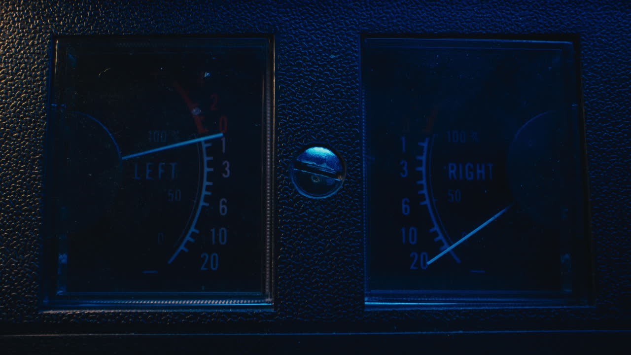 A close-up on a vintage tape recorder in a blue light