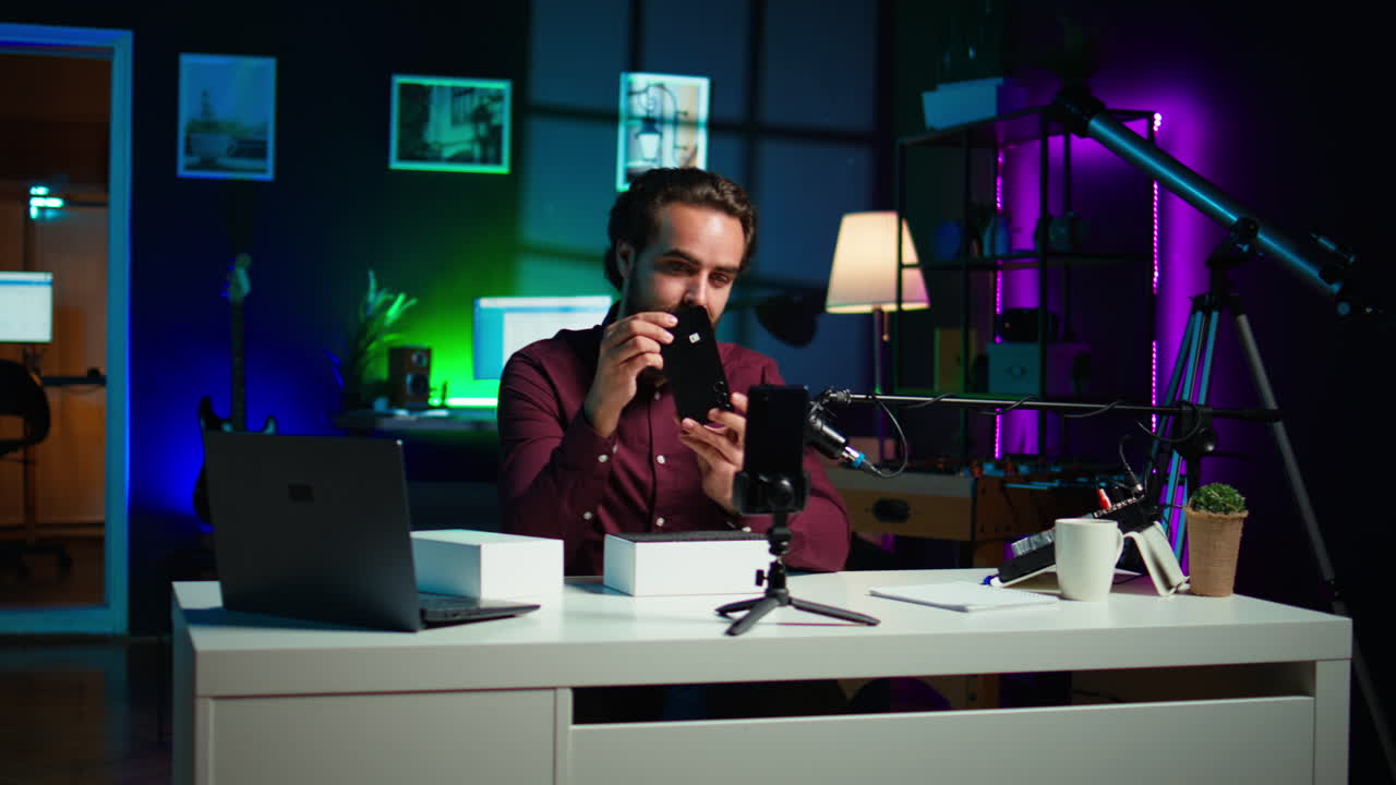 L'artista presenta uno smartphone del marchio sponsor