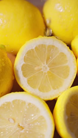 lemon juice falling or dripping onto a cut lemon in slow motion