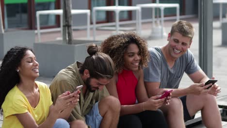 cheerful friends using smartphones