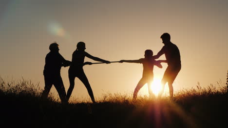 children and adults compete in tug of war a healthy and active lifestyle