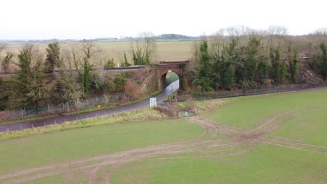 drone footage flying away from railway bridge in the kent countryside village