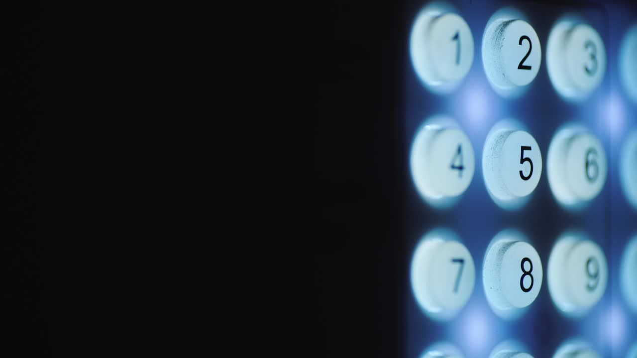 A person enters a pin code on a backlit keyboard