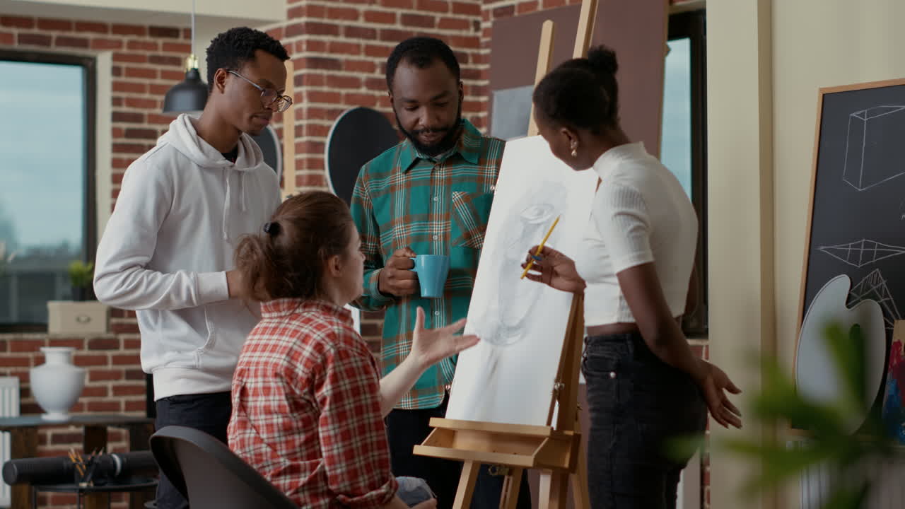 Group of art students using drawing skills to sketch vase model
