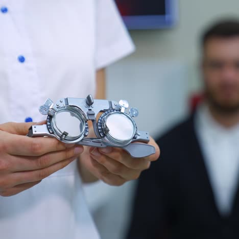 ophthalmologist examining young man in clinic