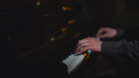 person playing piano in the dark