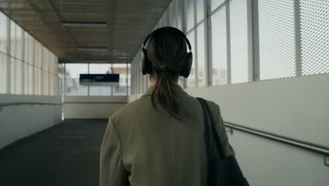 woman walking through an overhead walkway