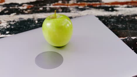 green apple on laptop