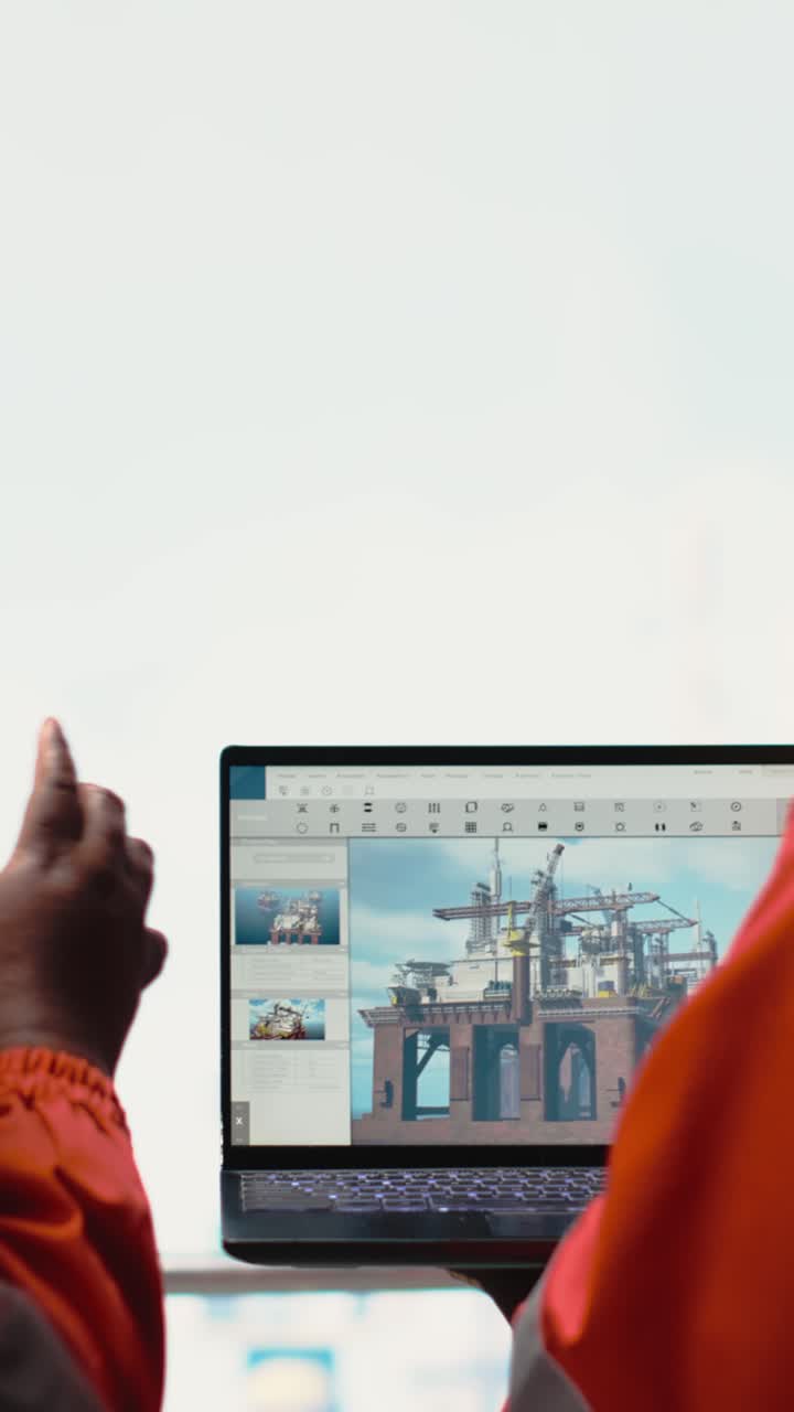 Vertical video Drilling rig boat engineering team using laptop to monitor equipment systems