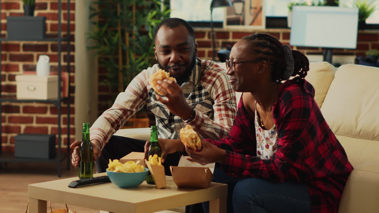 African american people eating burgers and fries