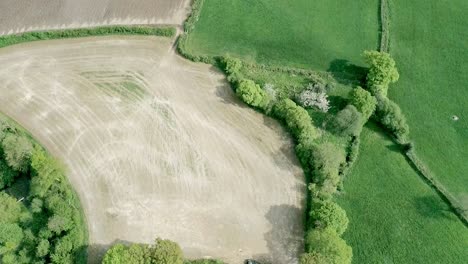 top down of various coloured fields all at different points ofproduction with different crops