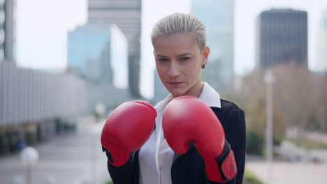 determined businesswoman in boxing gloves