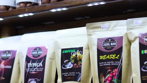 various coffee packages displayed on wooden shelves