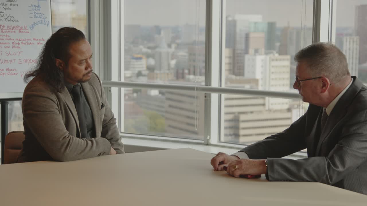 Serious Business Meeting Between Two Men in a Modern Office