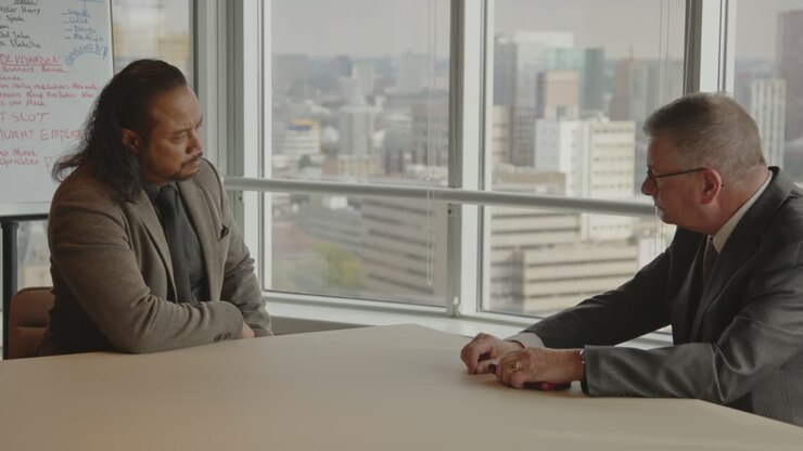 Serious Business Meeting Between Two Men in a Modern Office