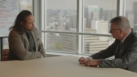 serious business meeting between two men in a modern office