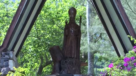 statue of monsignor dordillon in the gardens of notre dame cathedral in taiohae, nuku hiva, french polynesia