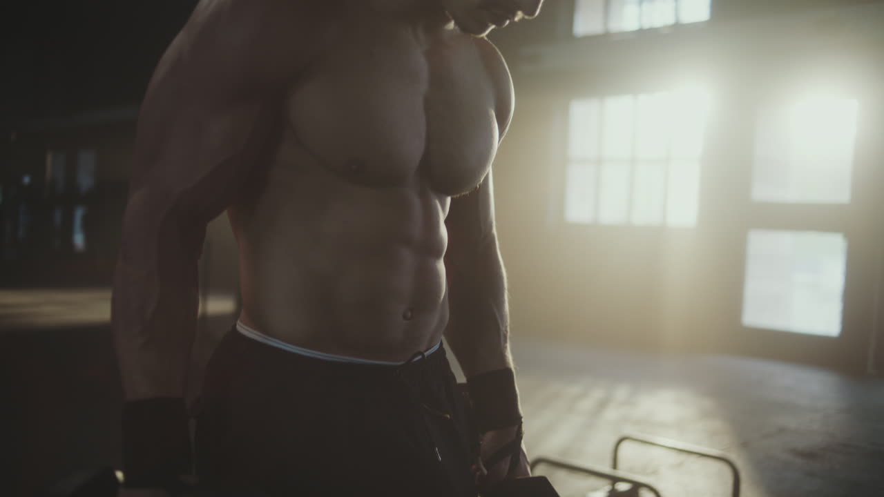 Muscular Man Working Out at Gym